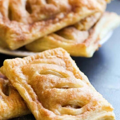 Stacked Apple Hand Pies on a black background.