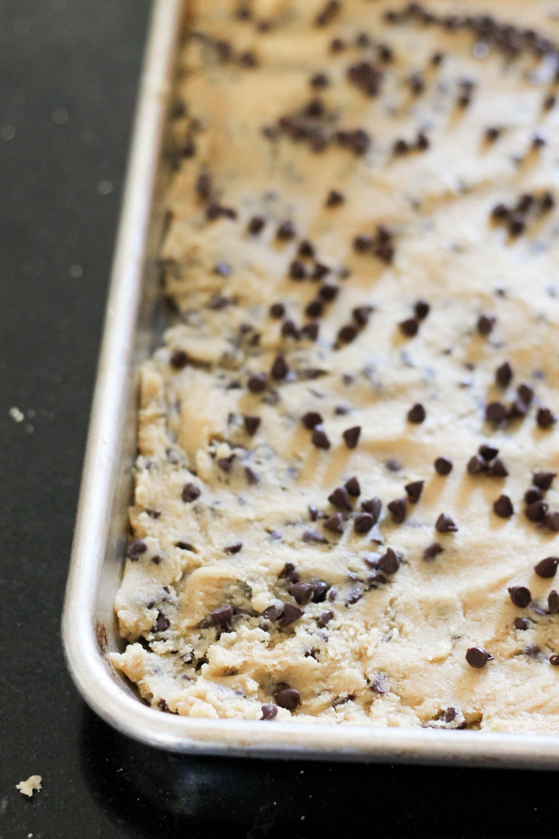 Pressed cookie dough unbaked in sheet pan