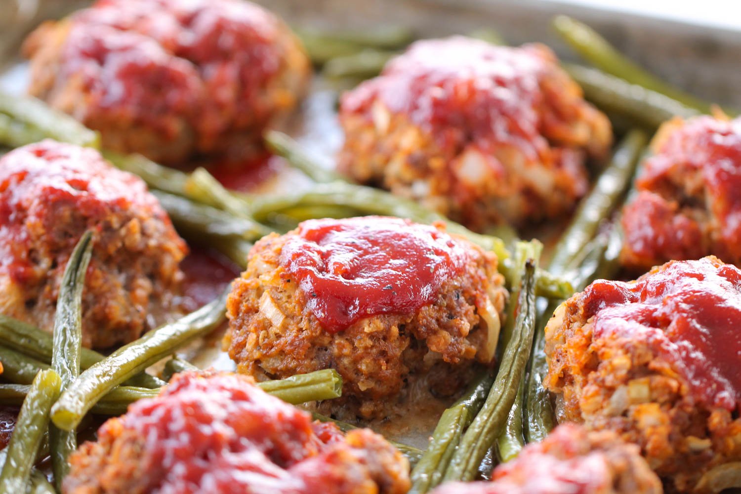 Sheet pan meatloaf patties and green beans.