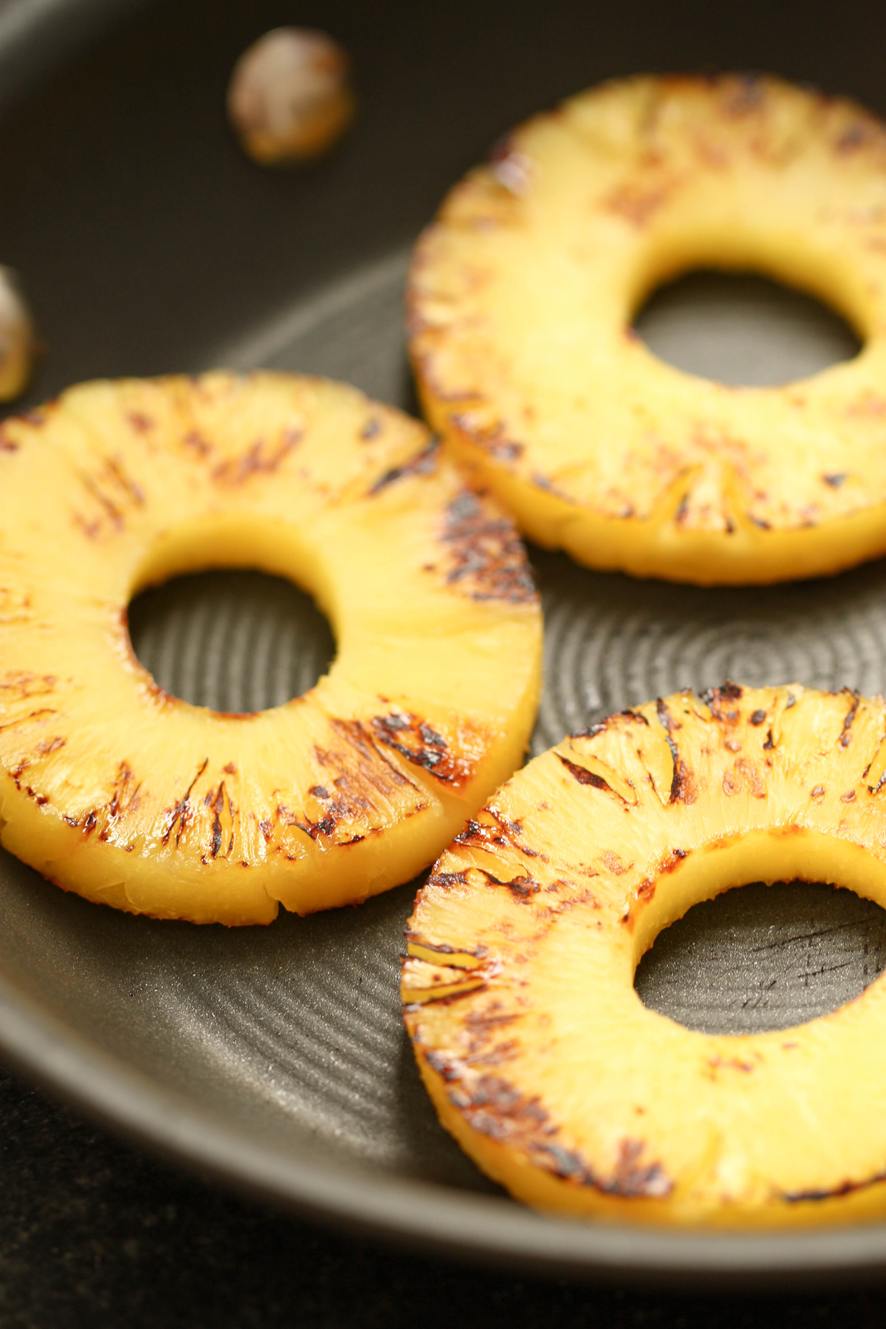 Grilled pineapple rings in a pan