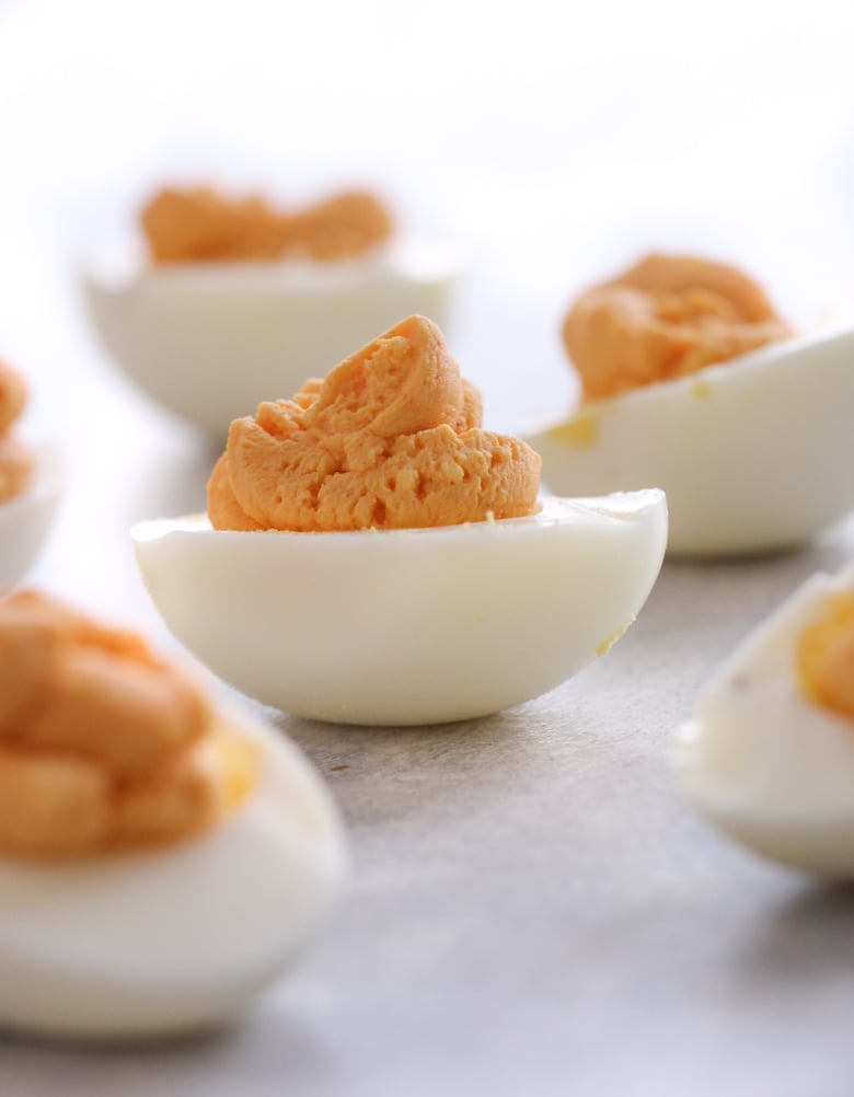 Buffalo Ranch Deviled Eggs without toppings on a plate