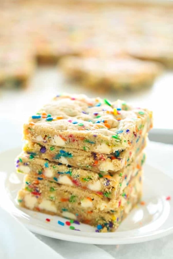 4 Sheet Pan Funfetti Cookie Bars stacked on a plate.