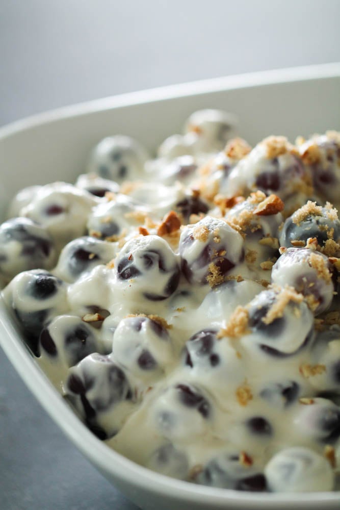 grape salad in serving dish with walnuts on top