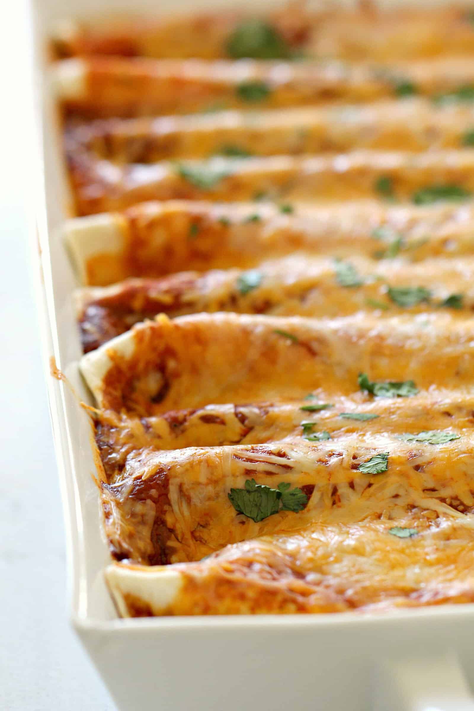 Creamy Three Bean Enchiladas in white casserole dish