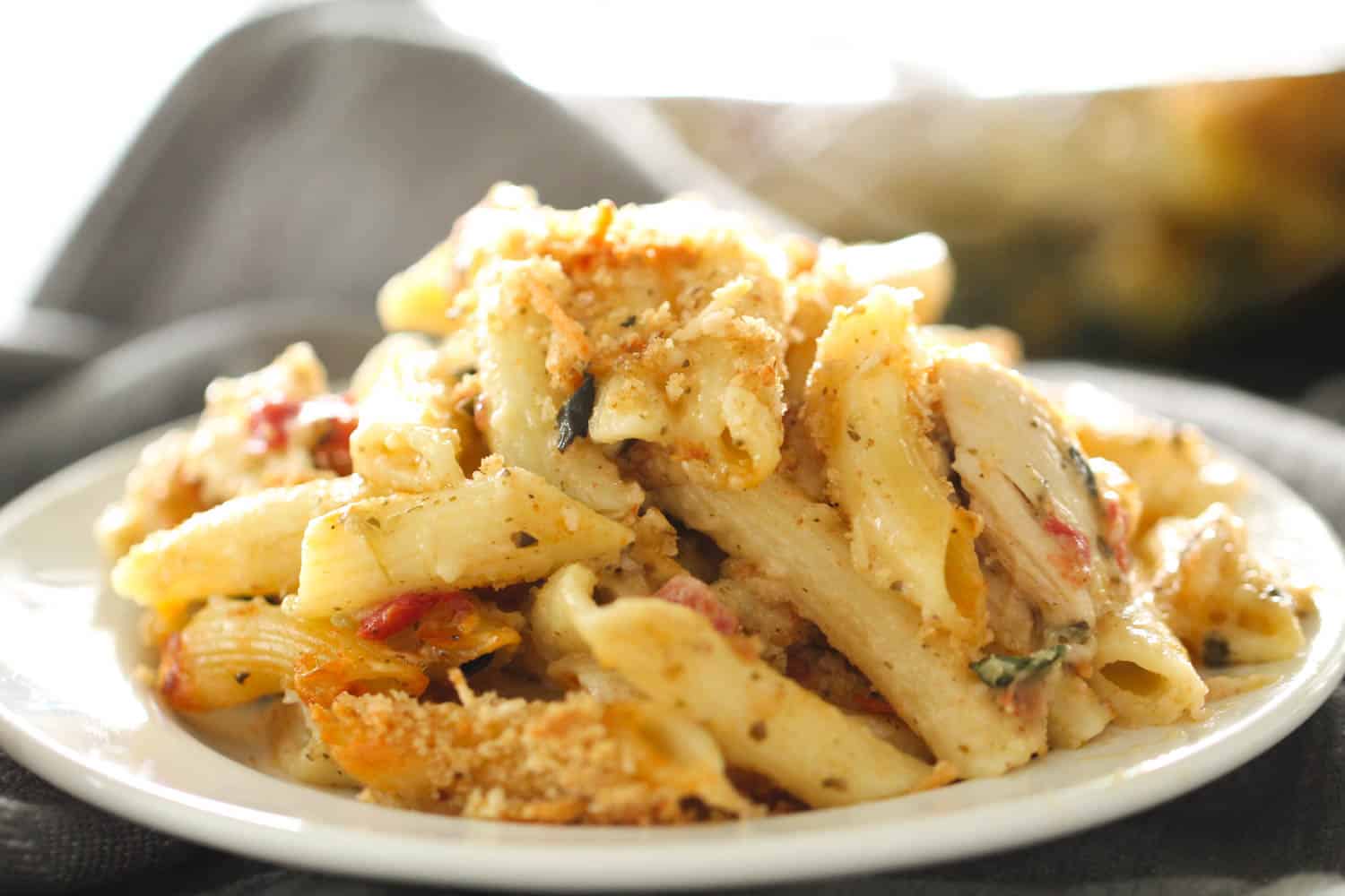 pesto chicken pasta bake served on white dish