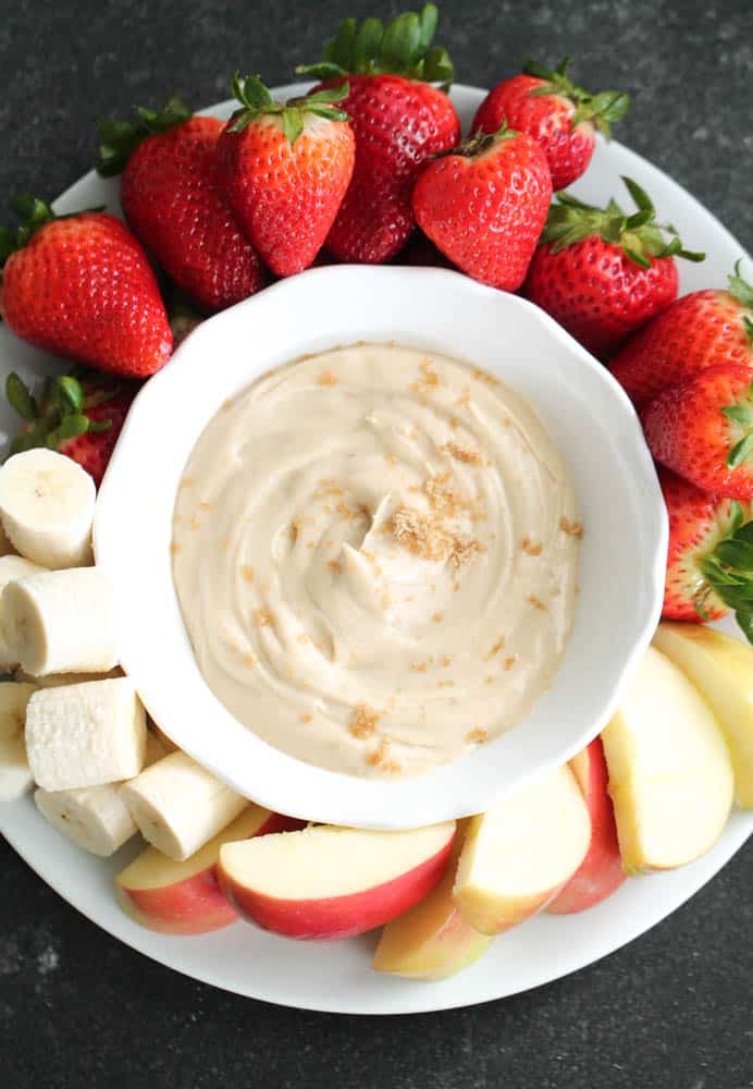 Brown sugar fruit dip in bowl served with various fruits