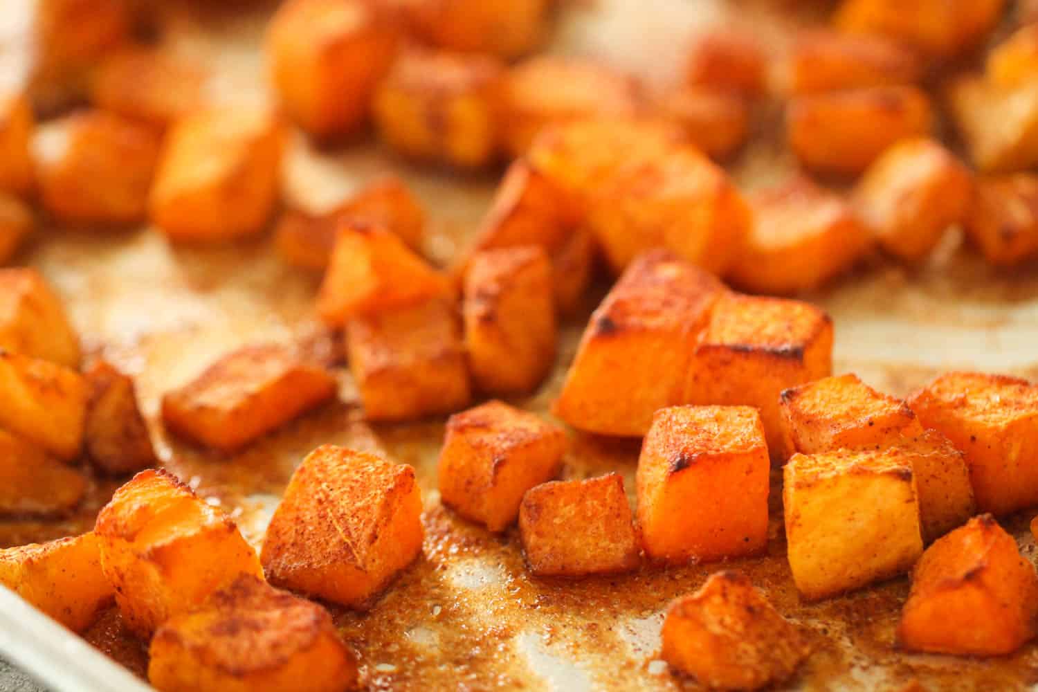 Cubed butternut squash on a sheet pan