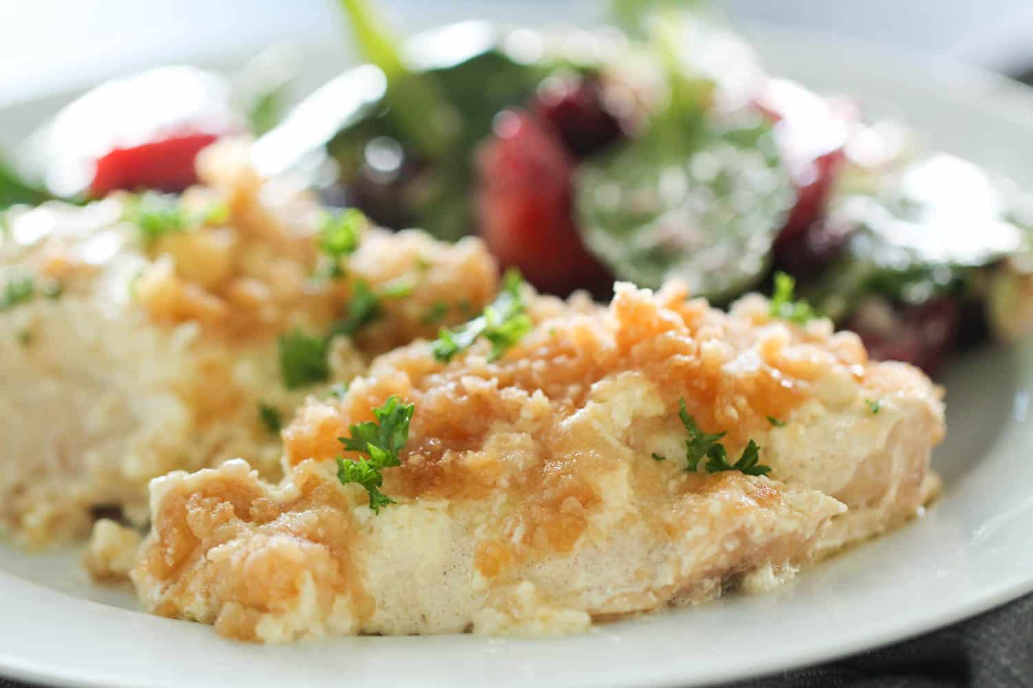 Slow Cooker Ritz Chicken on a white plate served with vegetables