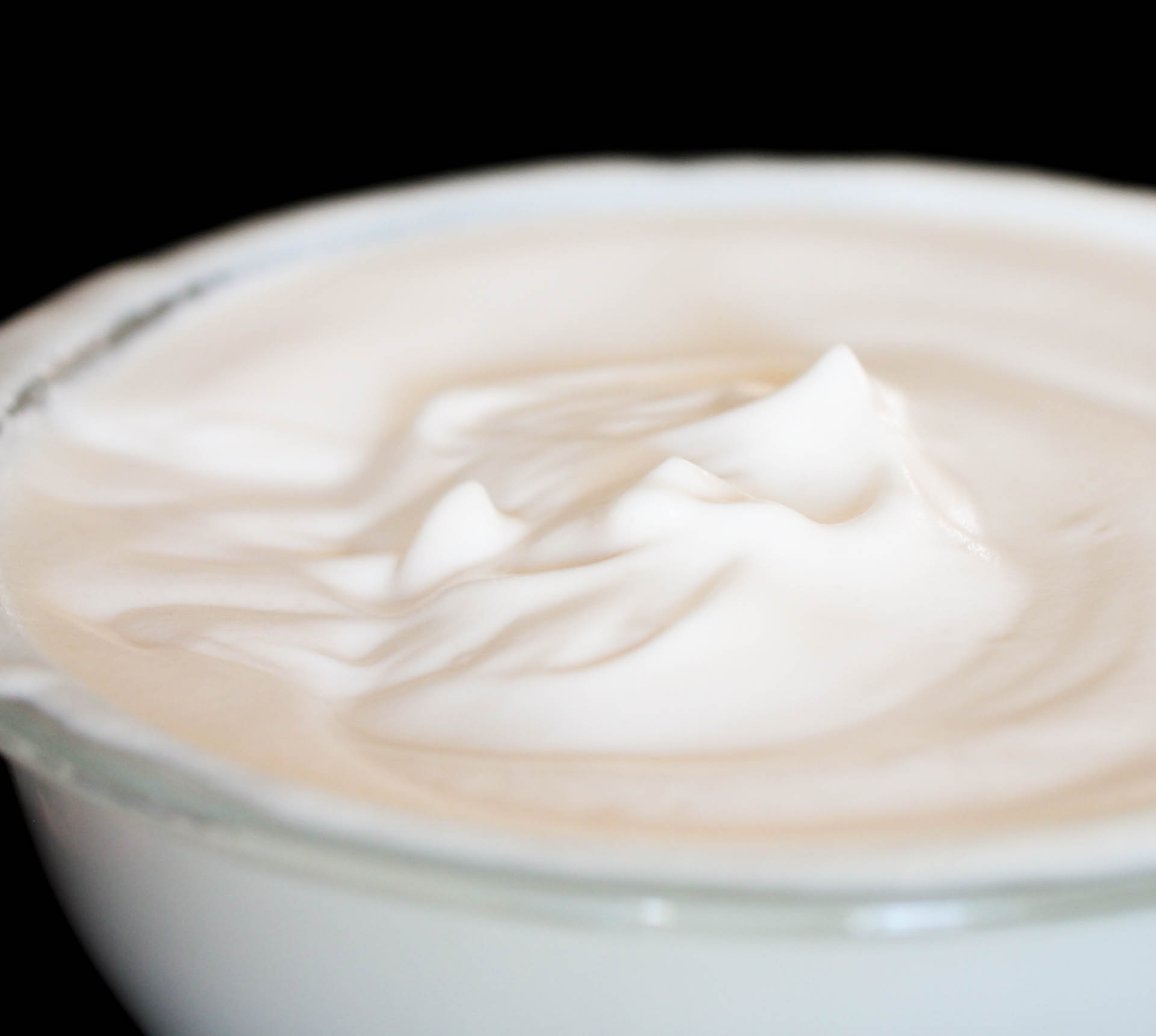 Fluffed whipped evaporated milk in a glass bowl