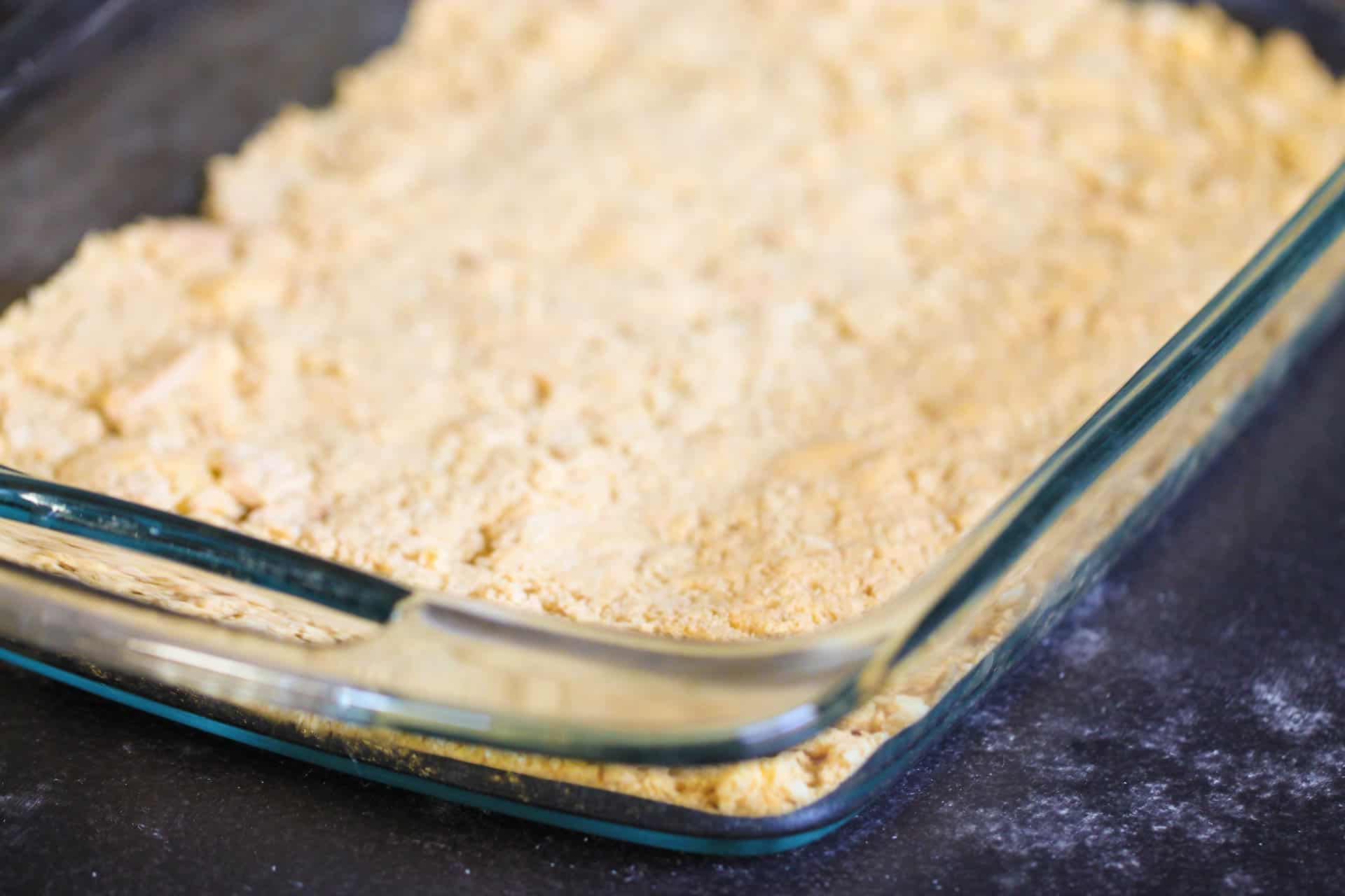 Blended golden oreo cookies in the bottom of a 9x13 glass pan