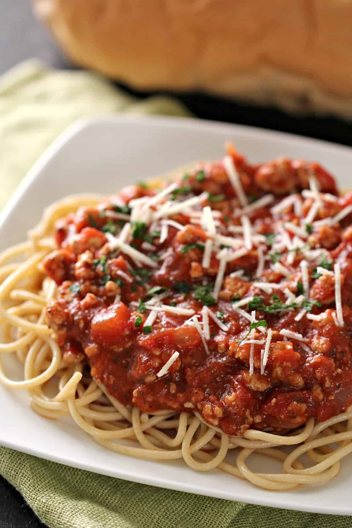 Ground turkey spaghetti sauce on spaghetti plated.