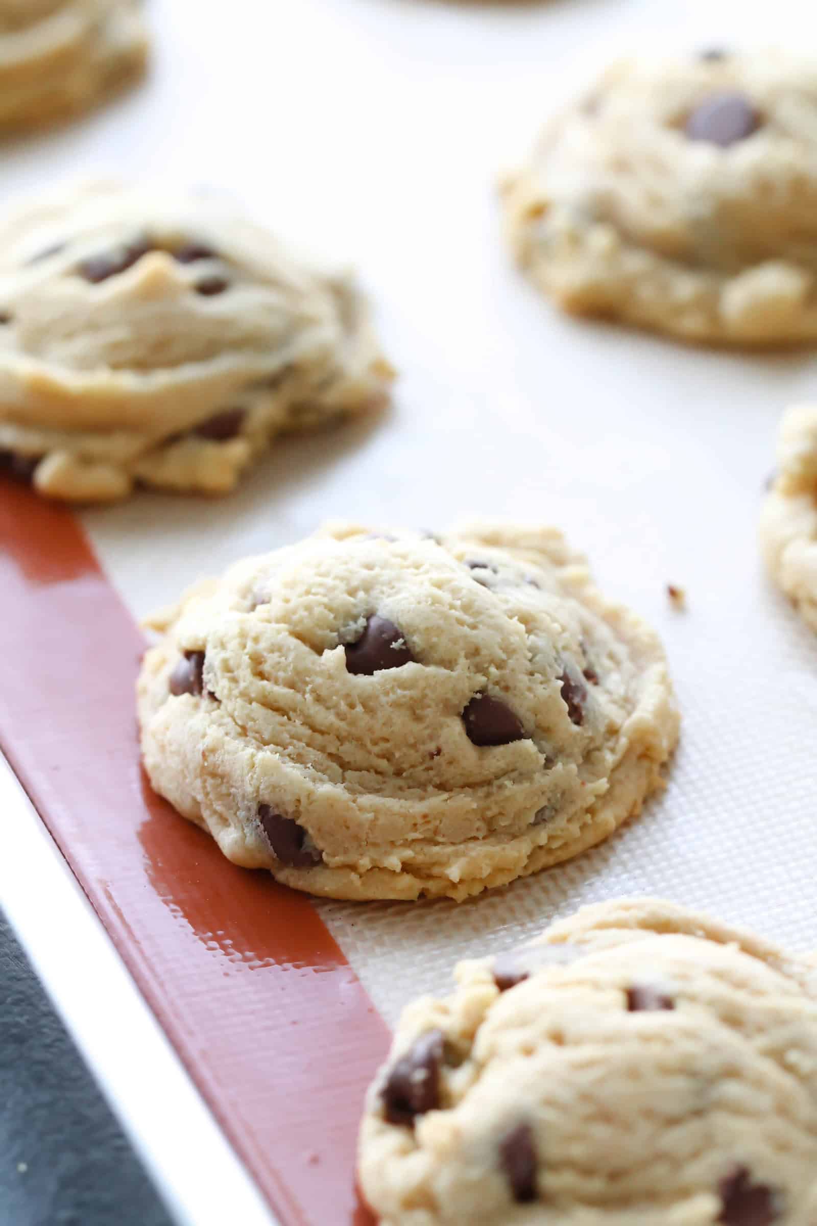 Close up of Chocolate Chip Pudding Cookies
on a baking sheet lined with a silpat liner.