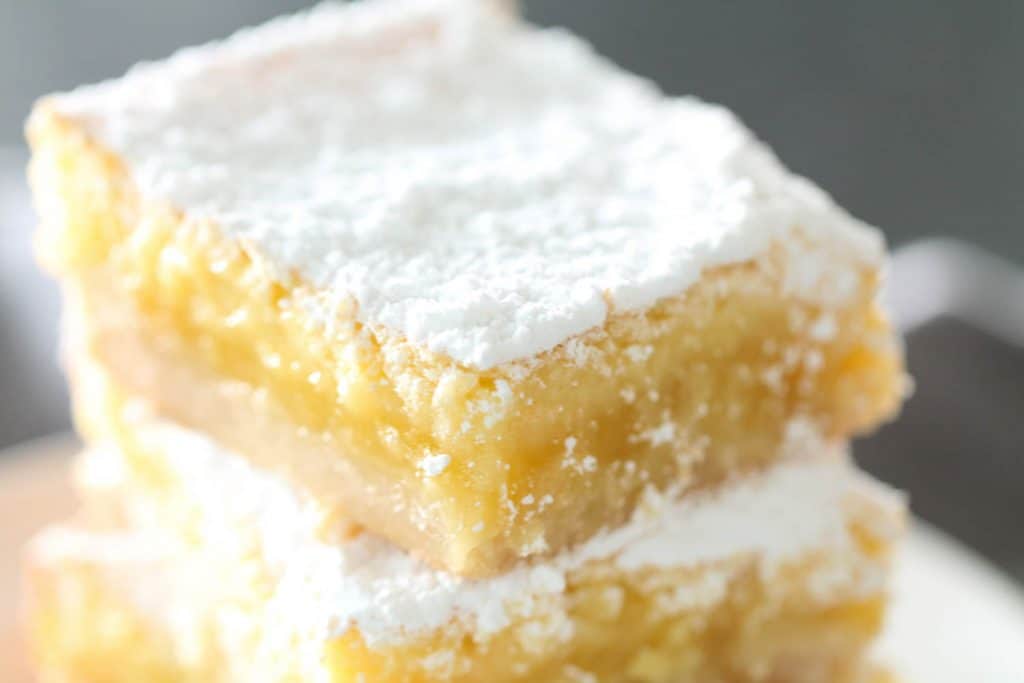 A stack of lemon bars on a plate.