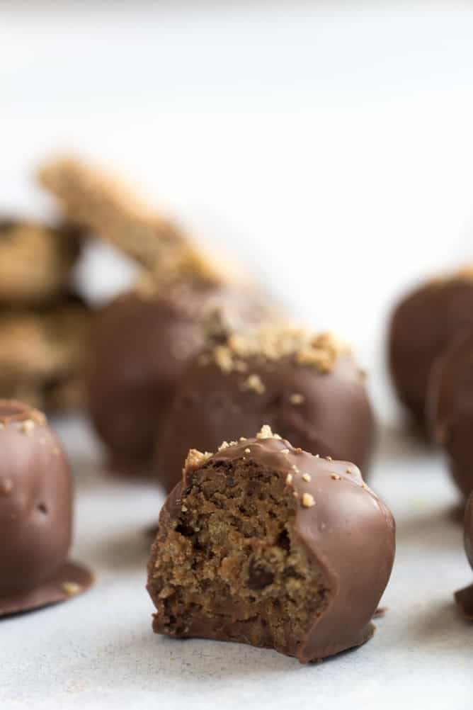 Close up of a Chocolate Chip Cookie Truffles with the one in front missing a bite.