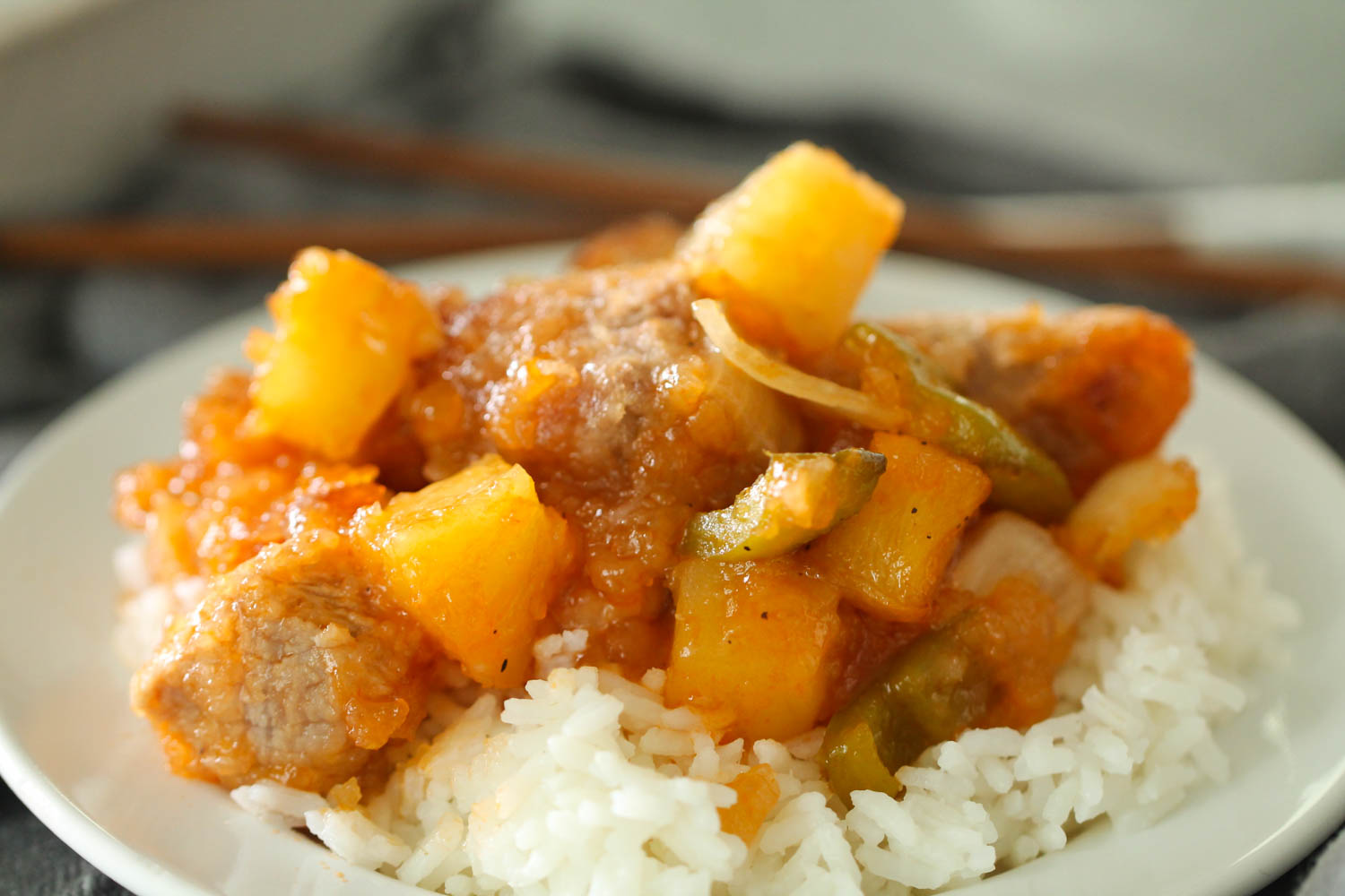 Easy Baked Sweet and Sour Pork served over rice on a plate