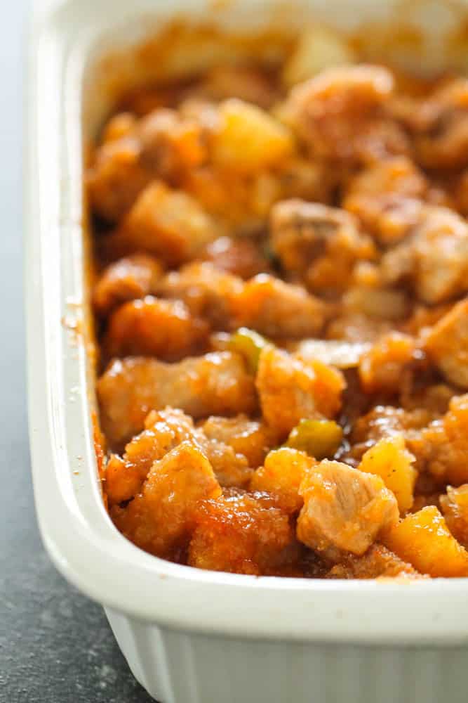 Easy Baked Sweet and Sour Pork in white baking dish.