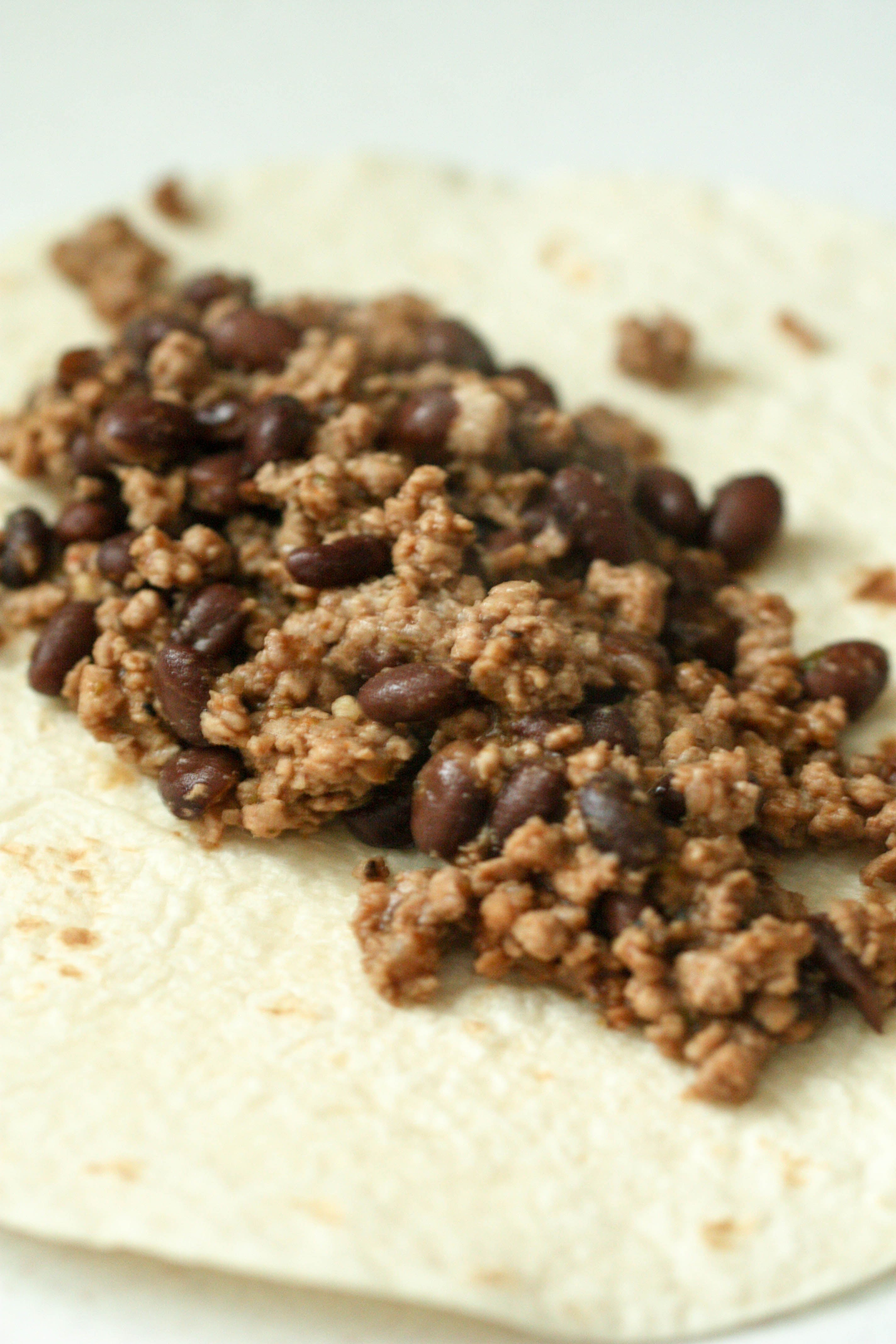 Tortilla with ground turkey and black beans in the center