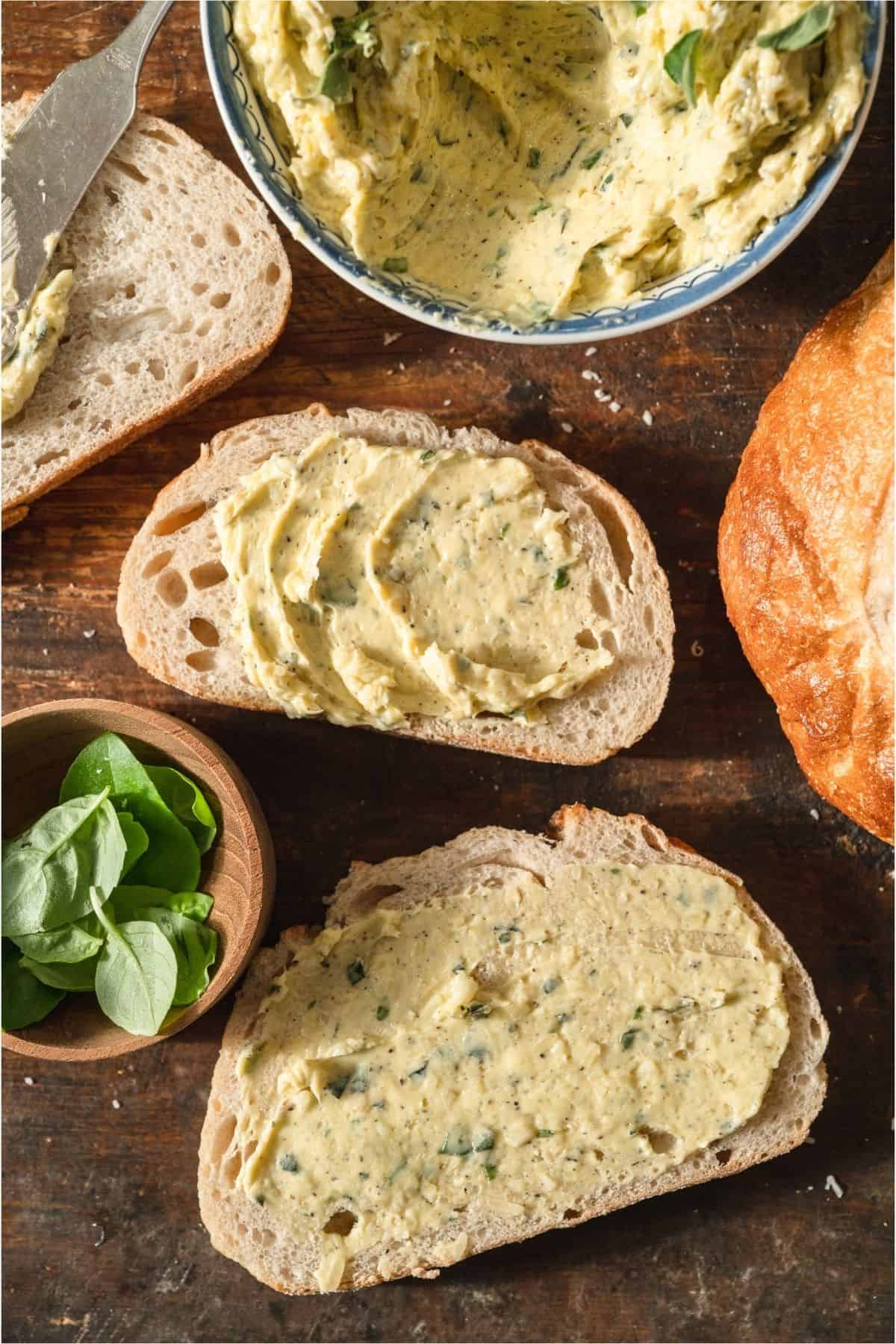 Two slices of bread with garlic butter spread on them.