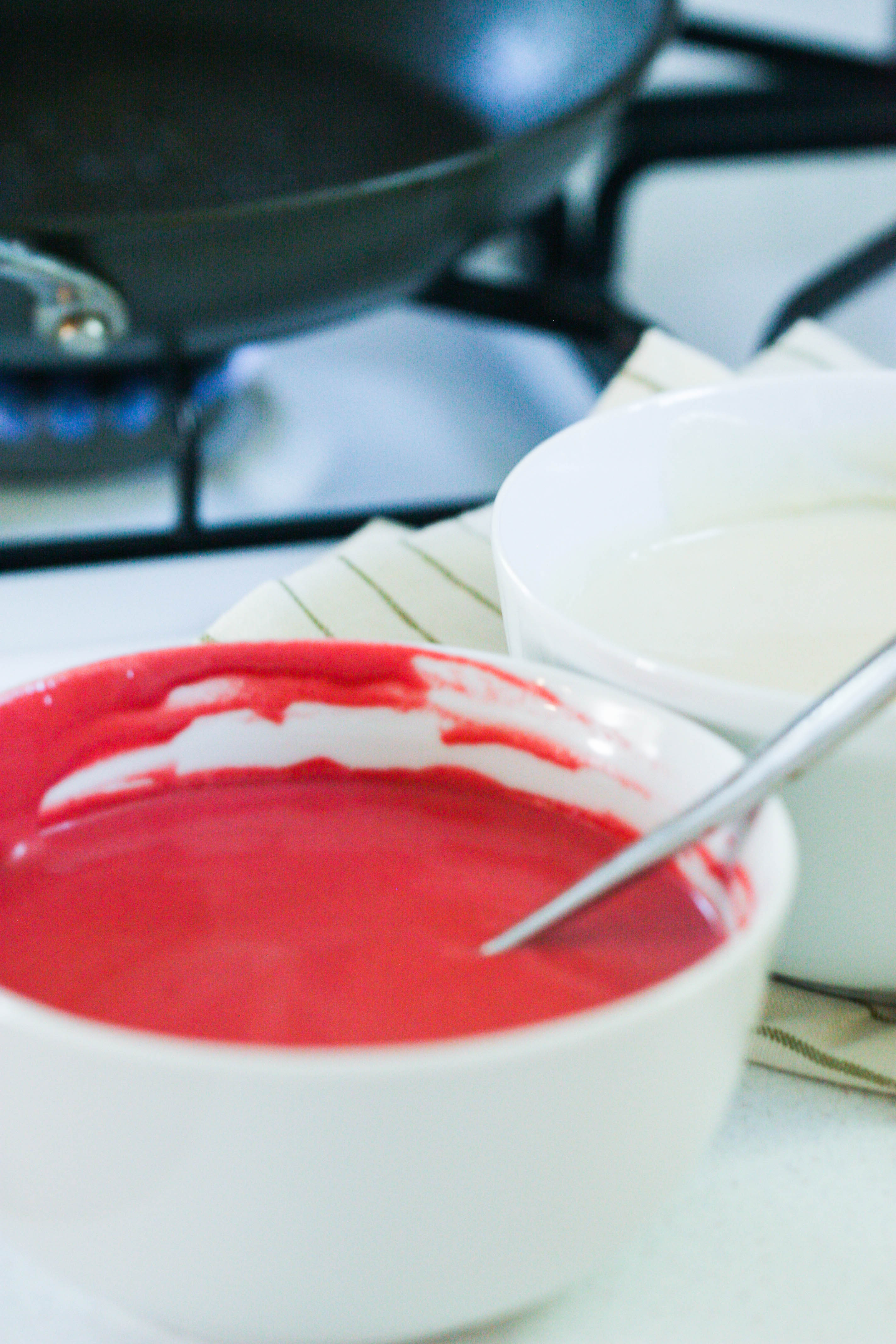 Red crepe batter in a mixing bowl