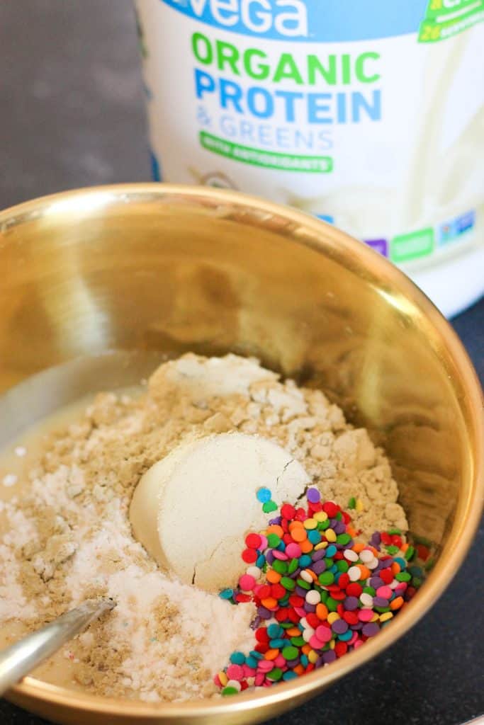 Mixing Protein, sprinkles and cake mix in a mixing bowl.