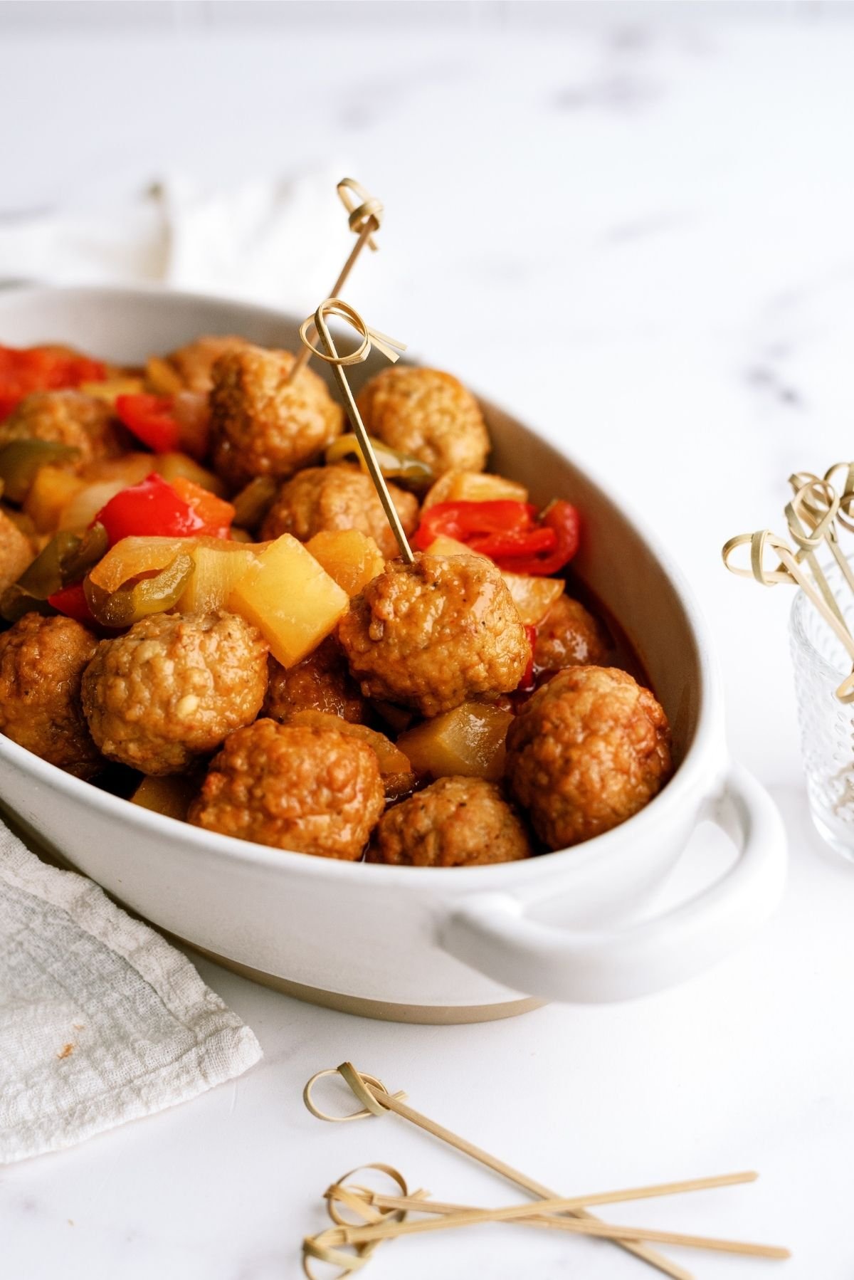 Slow Cooker Sweet and Sour Meatballs in a serving dish with toothpicks