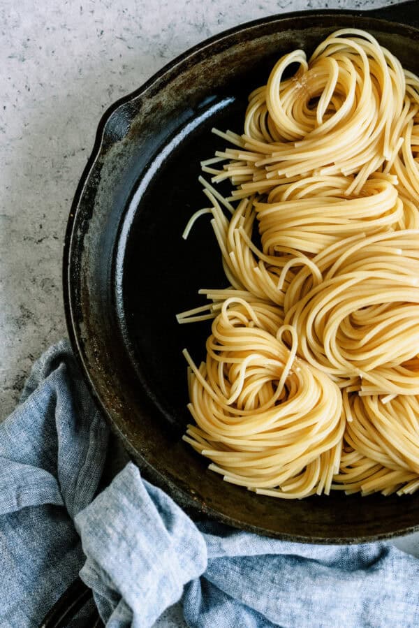 Cooked spaghetti noodles in skillet