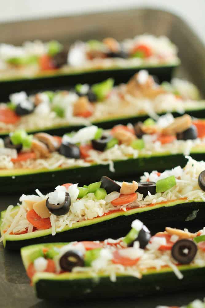 Toppings and fillings inside Zucchini boats on sheet pan