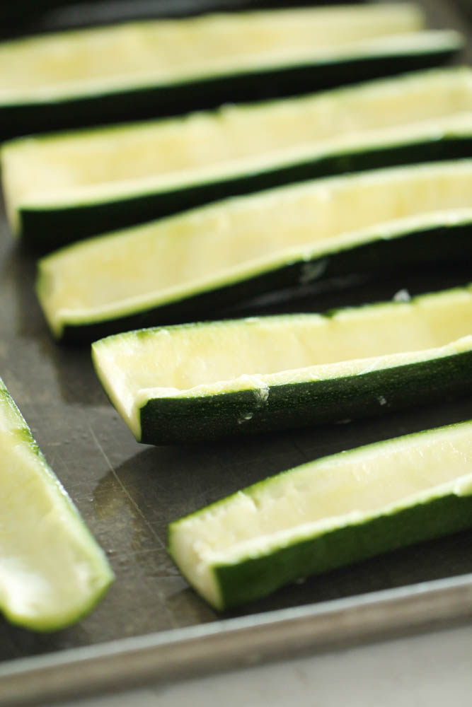 Scrape out the sliced zucchini on a sheet pan