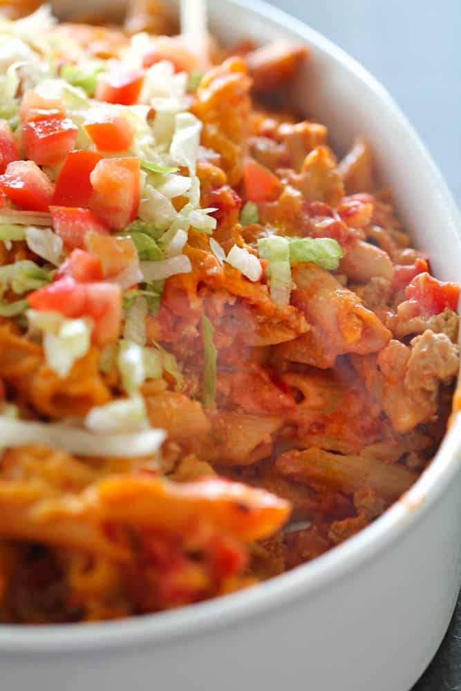 Skinny Cheeseburger Casserole topped with lettuce and tomatoes