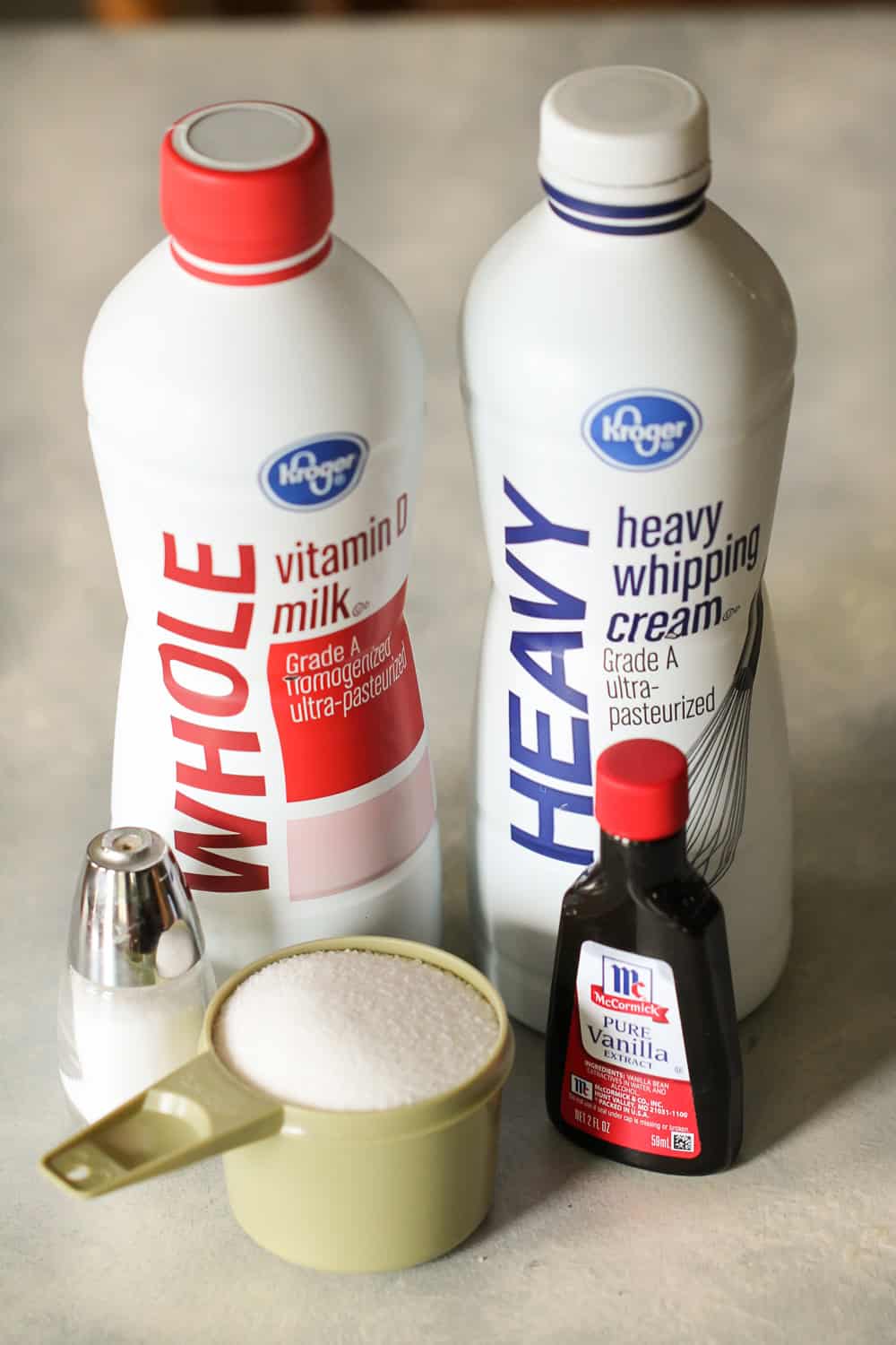 Whole milk and heavy whipping cream bottles, vanilla, sugar and salt