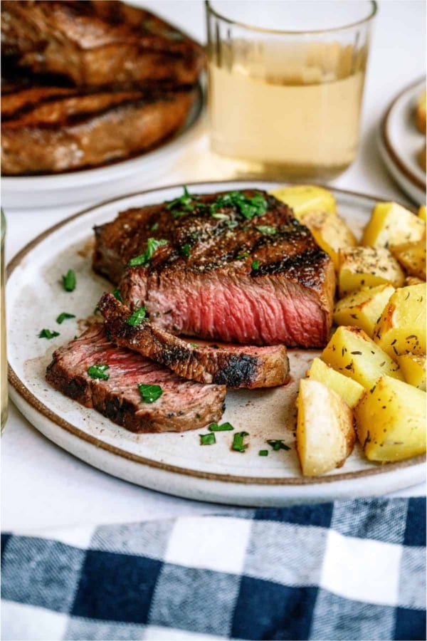 Mom's Steak Marinade Sliced Steak on a plate with potatoes