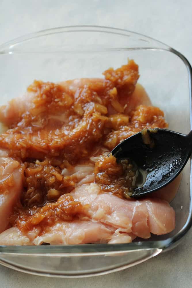 Chicken in a baking dish topped with pineapple mixture