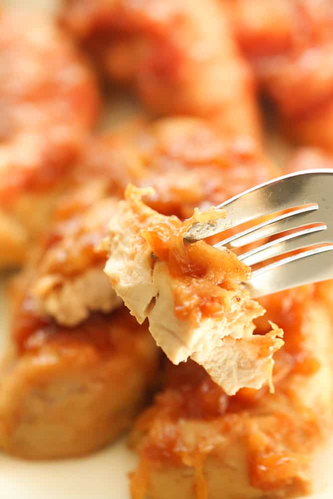 Pineapple Chicken Tenders with a piece on a fork