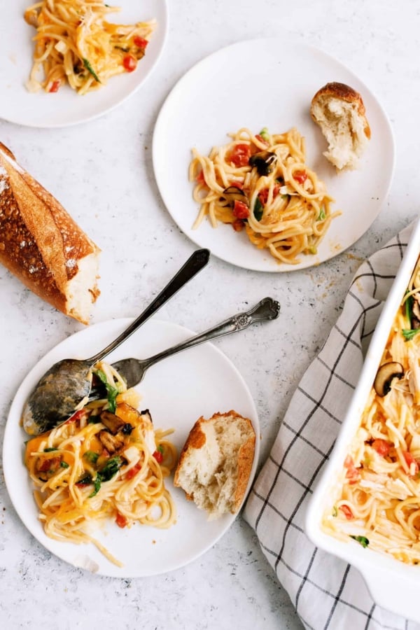 Top view of two servings of Chicken Spaghetti Casserole on plates.