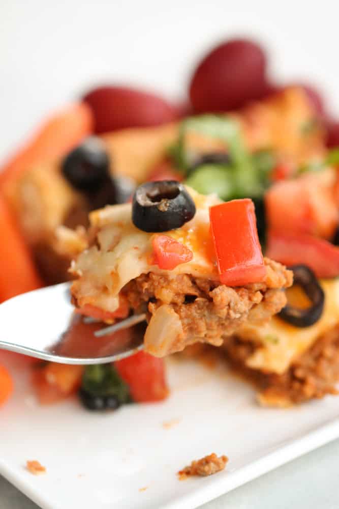 Slice of Crescent Roll Burrito Bake on a plate with a fork