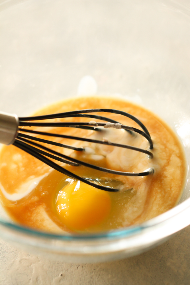 Egg mixture in a mixing bowl with a whisk