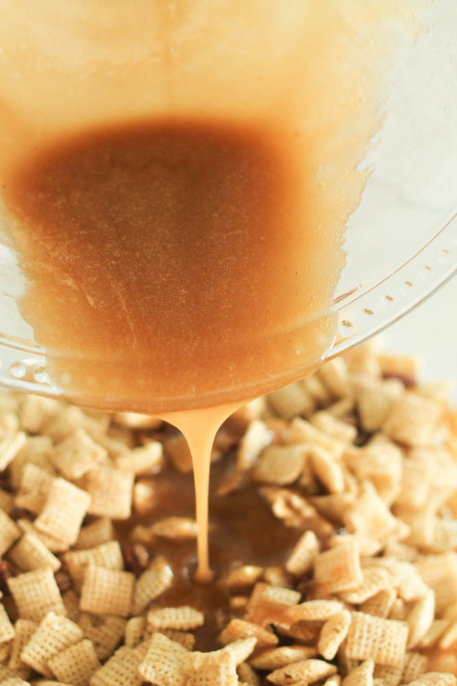 caramel sauce being drizzled over chex cereal in a bowl