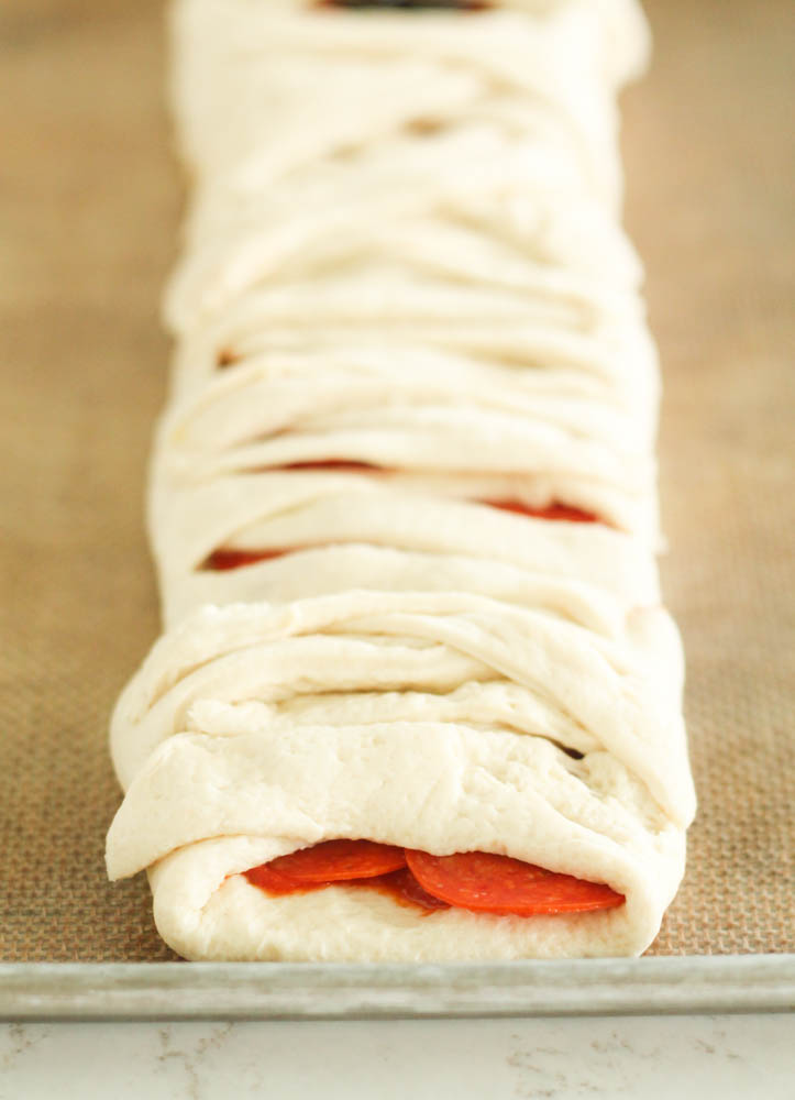 Folding strips around center of dough