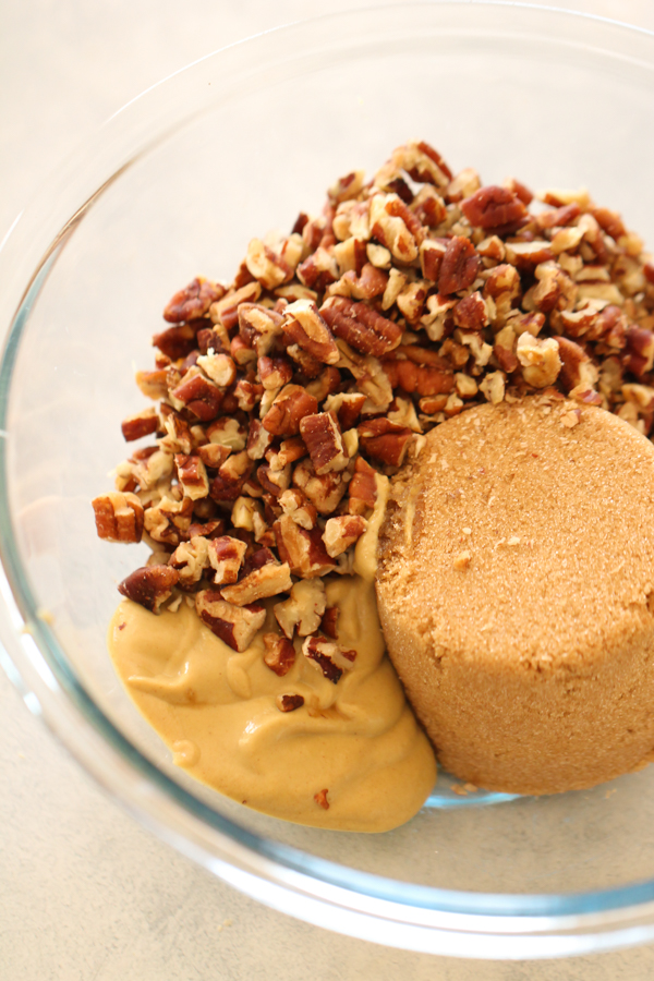 pecans, sugar and mustard in a glass mixing bowl