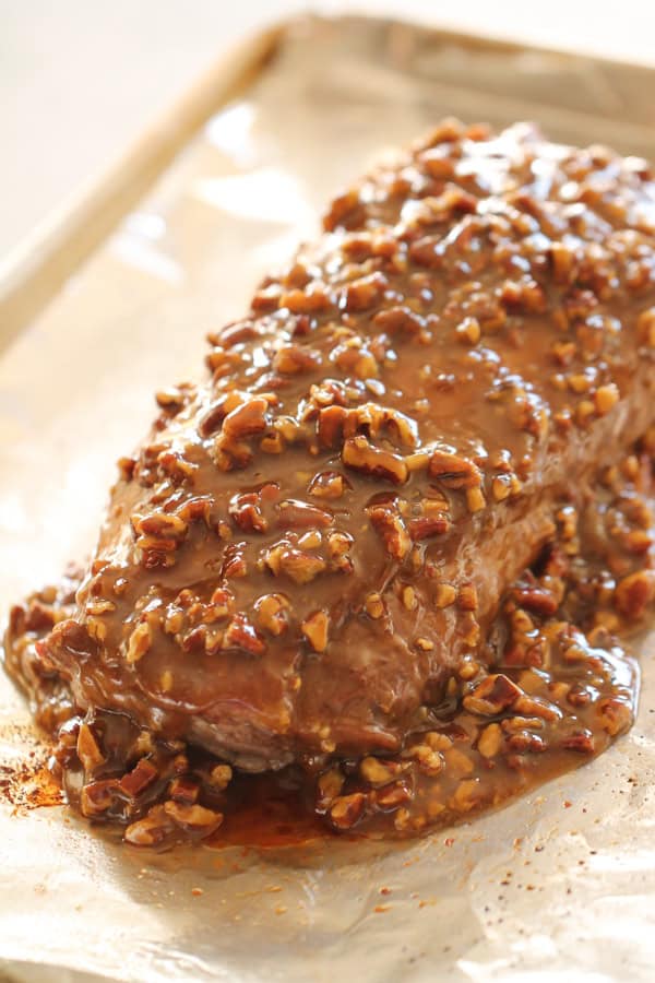 Pecan Mixture spooned over pork loin on baking sheet