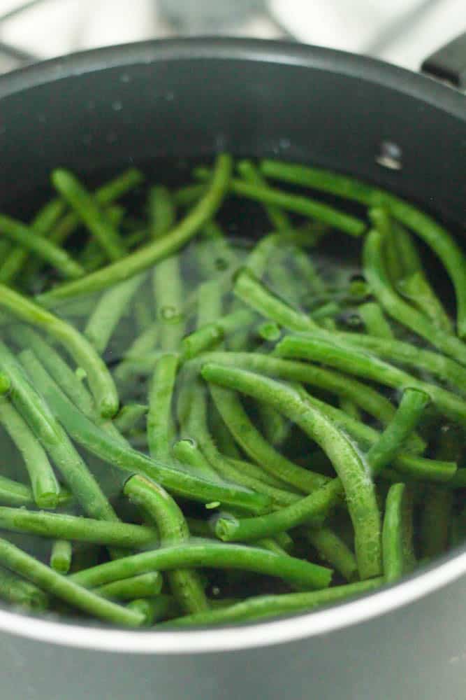 Fresh green beans sauteing in a pot