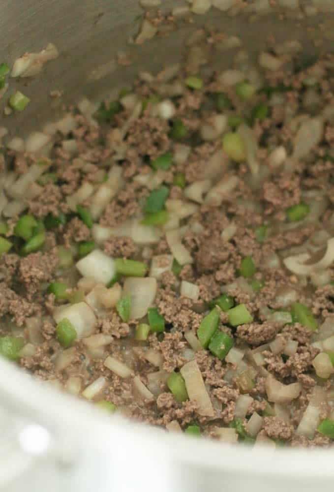 Ground beef with peppers and onions in skillet