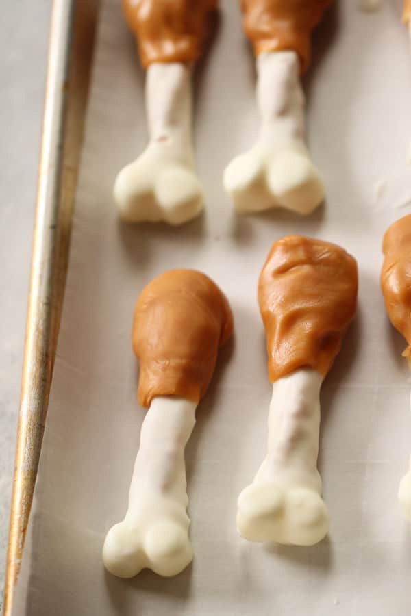 Softened caramels formed around top of pretzel rod