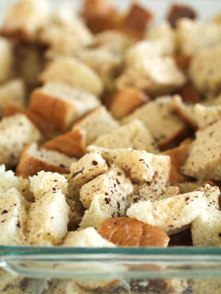 Egg mixture poured over cubed bread