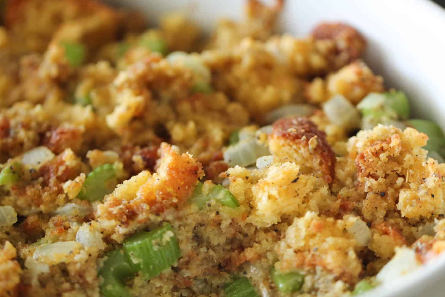 Homemade Corn Bread Stuffing in pan with close up image.
