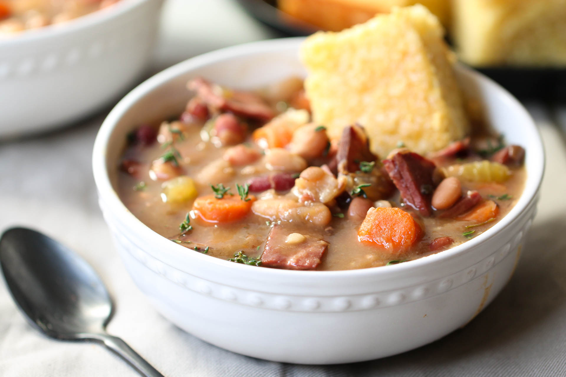 Slow Cooker Ham and Bean Soup in a bowl with bread