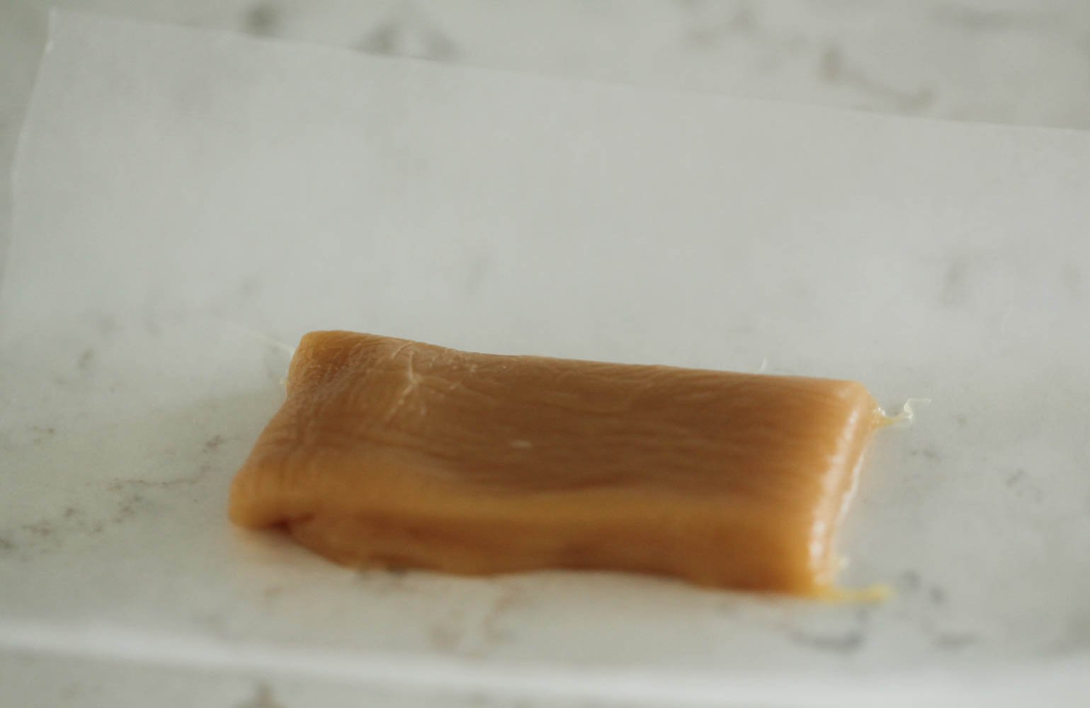Caramel piece waiting to be wrapped in wax paper