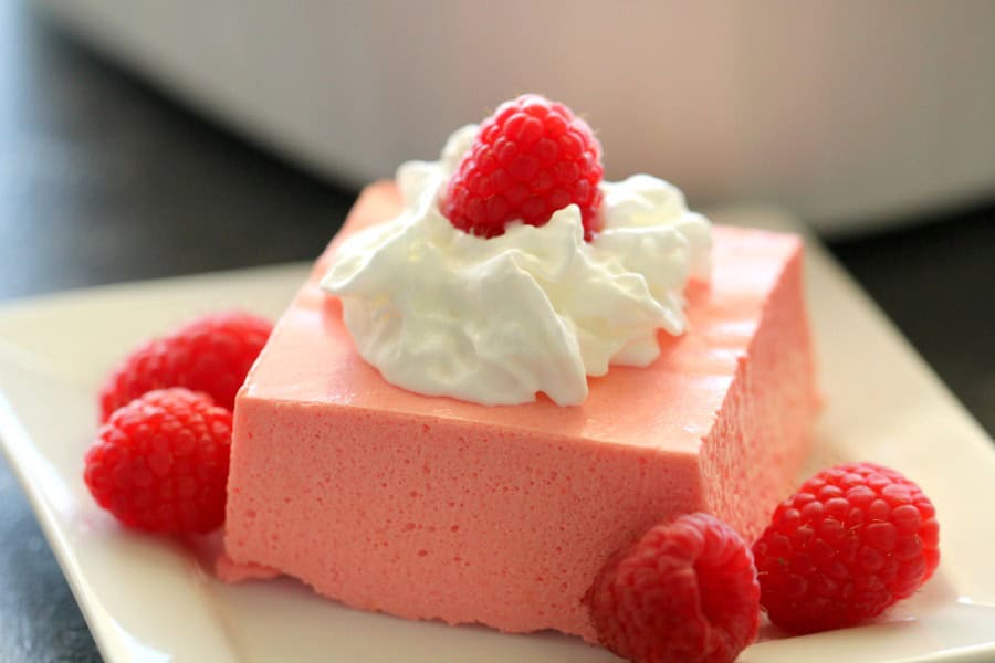 A slice of Raspberry Cream Cheese Jello Salad on white plate