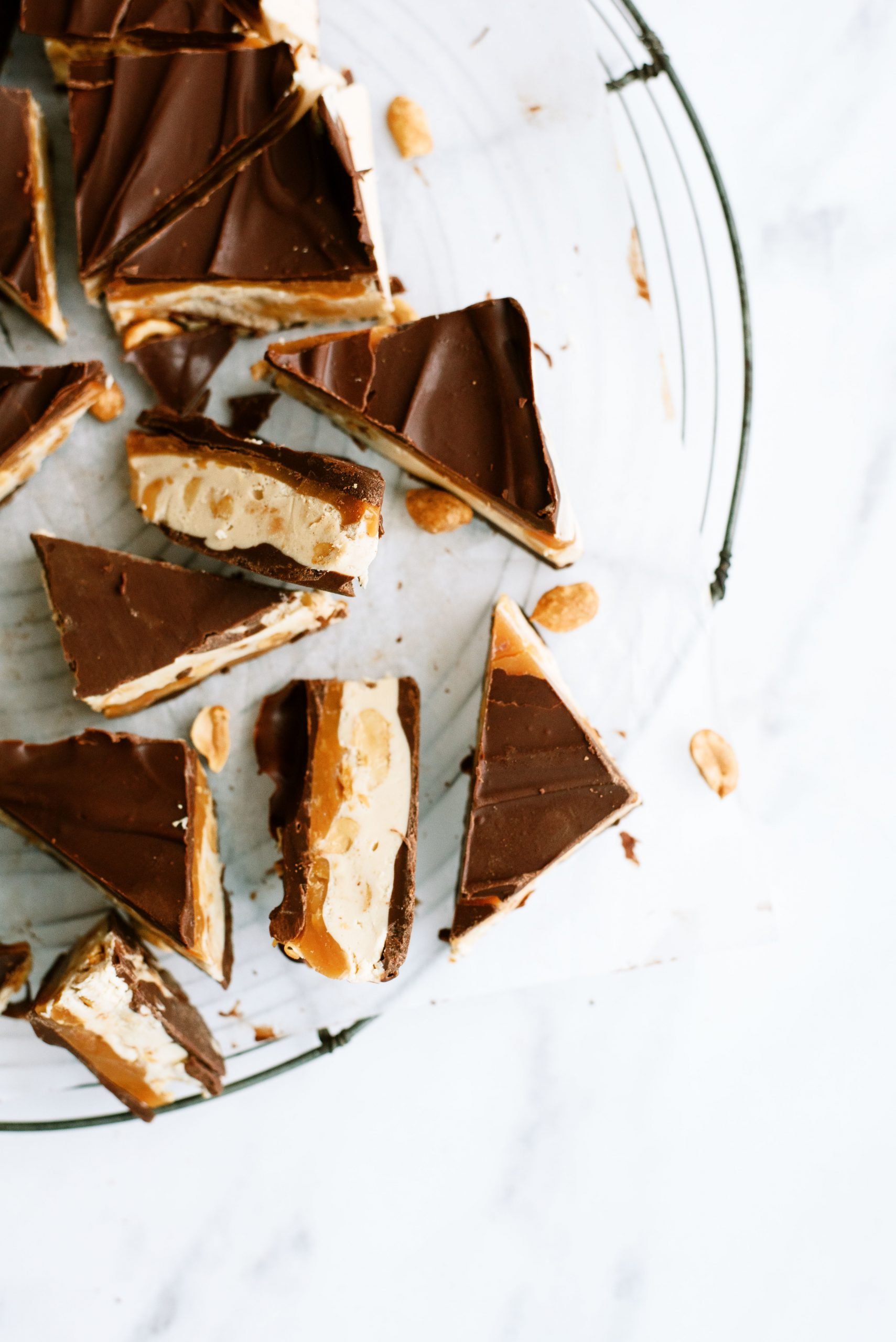 Snickers Fudge  sliced into pieces on a serving platter