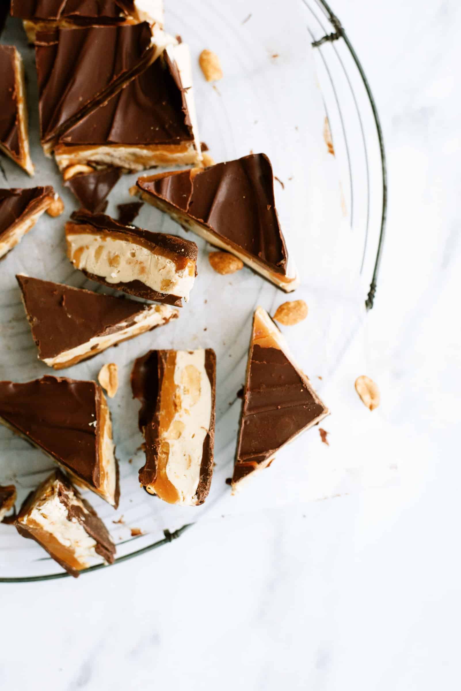Snickers Fudge sliced into pieces on a serving platter